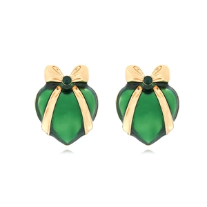 Detailed close-up of dark green enamel heart earrings with gold bow and tiny center diamond