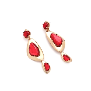 Close-up of red geometric rhinestone drop earrings with vintage gold metal plating