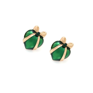Close-up of heart earrings with green enamel, golden bows, and vintage royal styling