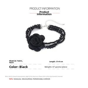Detail of multi-strand black resin bead choker with large textile rose flower and silver clasp