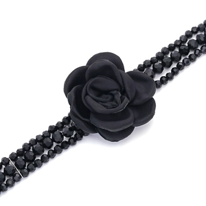 Handmade bohemian multilayer black beaded necklace with a detailed fabric rose flower