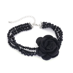 Three-layer black beaded choker necklace featuring a large handmade fabric camellia flower