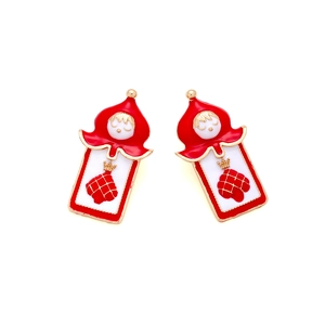 Detail of red enamel poker soldier earrings with gold trim and cartoon design