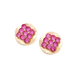 Detailed shot of vintage round gold-tone earrings with square-set pink gemstones