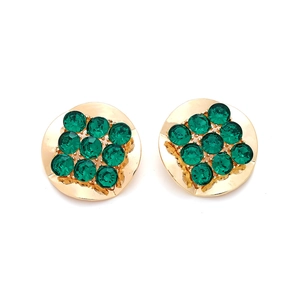 Detailed top view of vintage round gold earrings with green crystals in square pattern