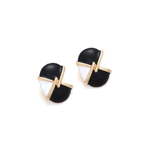 Close-up of vintage oval enamel button earrings with gold-tone cross lines and contrast trim