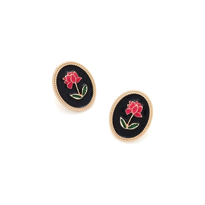 Detailed macro of oval black enamel earrings featuring a red rose and gold rope border
