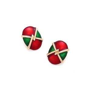 Detail of vintage oval alloy earrings featuring red and green enamel in a button style