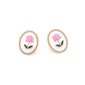 Detail of vintage oval stud earrings with pink rose enamel and golden woven edge
