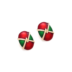 Detail view of oval gold alloy earrings with red and green enamel checkered pattern
