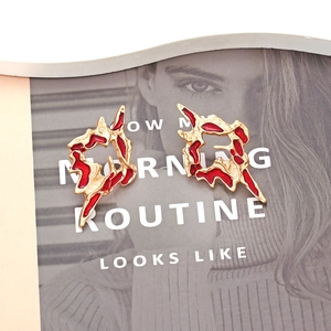 Modern irregular gold texture enamel earrings with molten lava design in vibrant red color