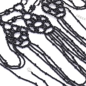 Handcrafted black beaded multi-layer body chain necklace with fringe tassels on white background