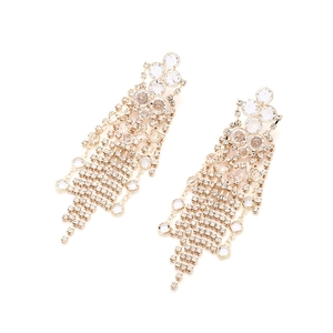 Detail of long gold tassel earrings with shimmering crystals in a waterfall design