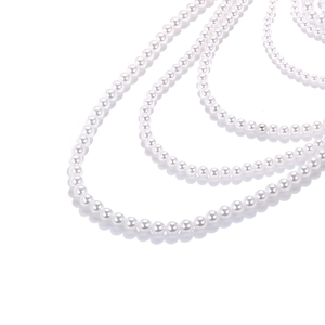 Close-up of multilayer faux pearl necklace with elegant round beads and lustrous finish