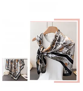 Detailed view of vintage floral print silk scarf featuring a black and beige classic pattern