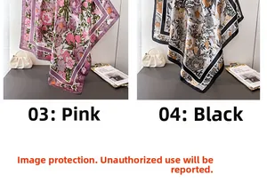 Detail of luxury silk-feel scarves with artistic flower patterns in pink and black gold