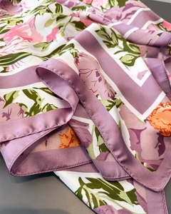 Detail of silk-like satin scarf featuring floral prints and premium stitched edges