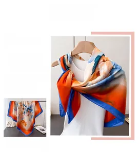 Detailed view of peony floral print silk scarf with elegant orange and blue patterns