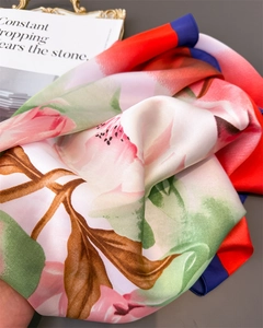 Close-up of floral silk scarf showing peony prints and red and blue contrast borders