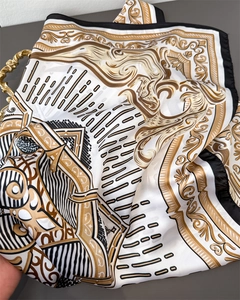 Detail of silk satin scarf with baroque scroll patterns and black border design