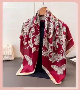 Close-up of silk scarf with burgundy floral butterfly prints hanging on a hanger