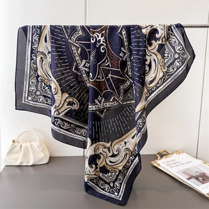 Baroque pattern silk-like square scarf in navy blue draped over a metal rod