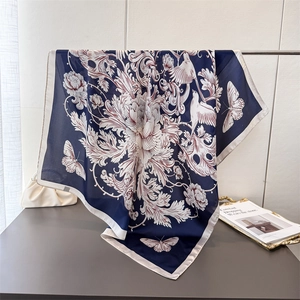 Navy silk-like scarf with baroque floral and bird prints featuring a white border edge