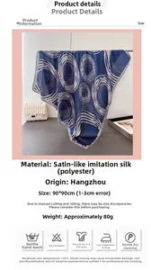 Detail of navy blue satin silk scarf featuring white abstract geometric ring patterns