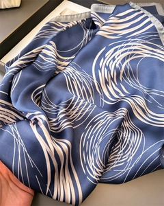 Detail of silk-satin scarf in navy blue with abstract geometric white circle patterns