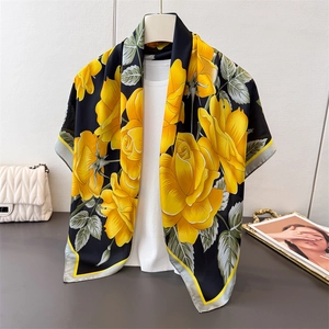 Romantic satin silk scarf with yellow rose print on black background worn with casual outfit