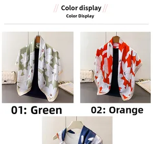 Detailed close-up of large white floral prints on satin silk scarves in green and orange