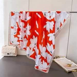 Elegant orange silk-like square scarf with white magnolia print and gold border