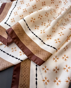 Makro-Detail eines seidigen Seidentuchs mit eleganten geometrischen Mustern und Textur