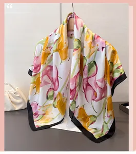 Detail of satin floral scarf with yellow petals and red blossoms on a wooden hanger