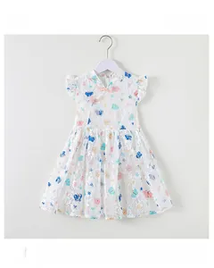 Detail of girls' white lace dress featuring colorful butterfly prints and ruffled sleeves