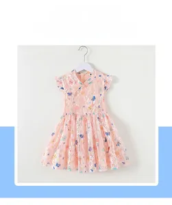 Detail of pink lace girls dress featuring butterfly prints and ruffled flutter sleeves