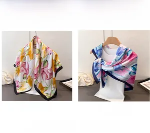 Detail of floral printed satin scarves in pink-yellow and pink-blue with elegant borders