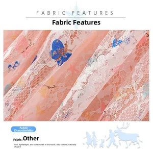 Close-up of pink lace fabric featuring embroidered blue butterflies and orange stars