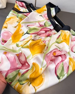 Detail of satin floral scarf with realistic pink tulips and a black border edge