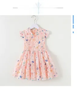 Detail of pink lace girls' dress featuring butterfly prints and ruffles