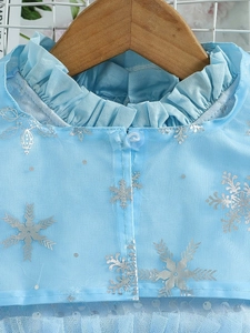 Blue Frozen-style princess dress with silver snowflake prints and a ruffled collar