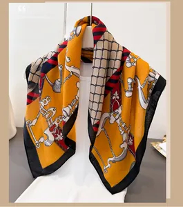 Detail of vintage herringbone scarf with orange chain pattern on a mannequin