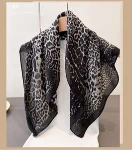 Detailed view of the semi-transparent black and grey leopard print lightweight scarf texture
