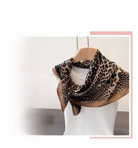 Detail of leopard print scarf with premium stitching displayed on a white mannequin