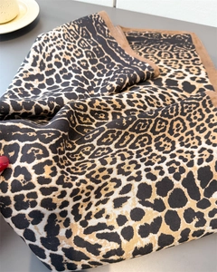 Detail of leopard print cotton linen shawl showing fine knit texture and brown hem