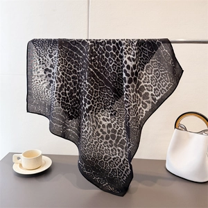 Leopard print cotton linen scarf in black and white displayed in a lifestyle setting