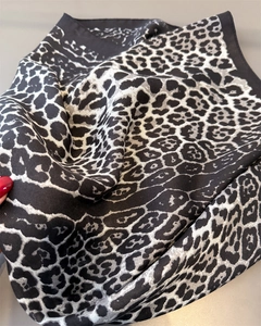 Close-up of leopard print cotton-linen scarf showing detailed twill texture and hem