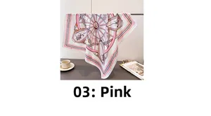 Detail of pink vintage carriage pattern silk scarf draped elegantly with refined texture