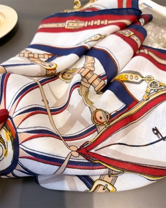 Close-up of vintage equestrian square scarf with classic buckle and strap pattern print