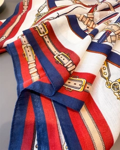 Detail of vintage equestrian scarf with horse harness patterns and high gloss silk texture